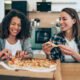 Two attractive women having fun with healthy food Takeaway Stockport