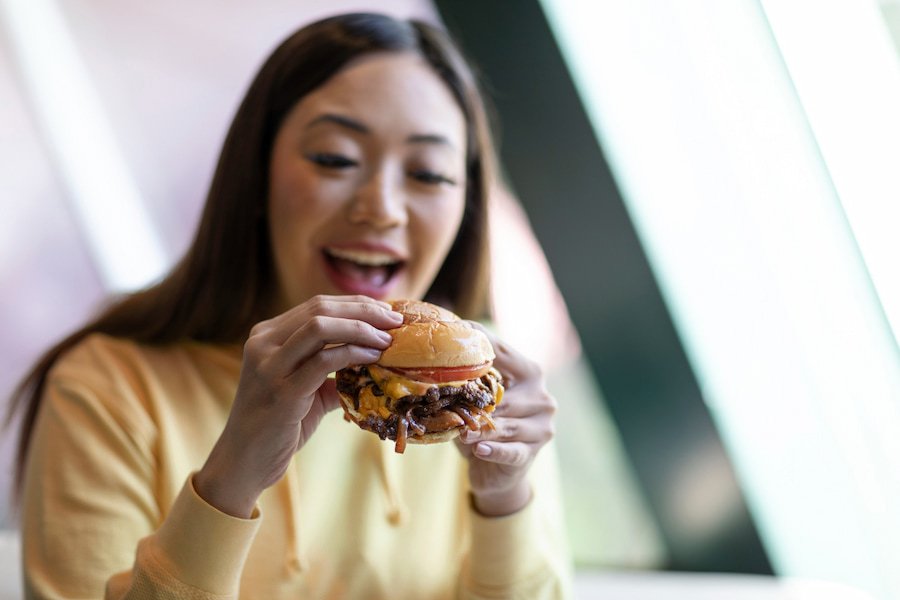 The Girl is eating Juiciest Burgers at home