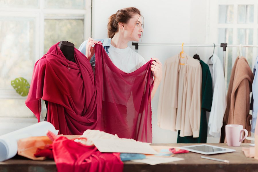 A woman inspecting fabric trends in a closet.